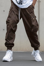 Men’s multi-pocket drawstring cargo pants by FitiqueFit, streetwear style, shown with multiple side and back pockets.