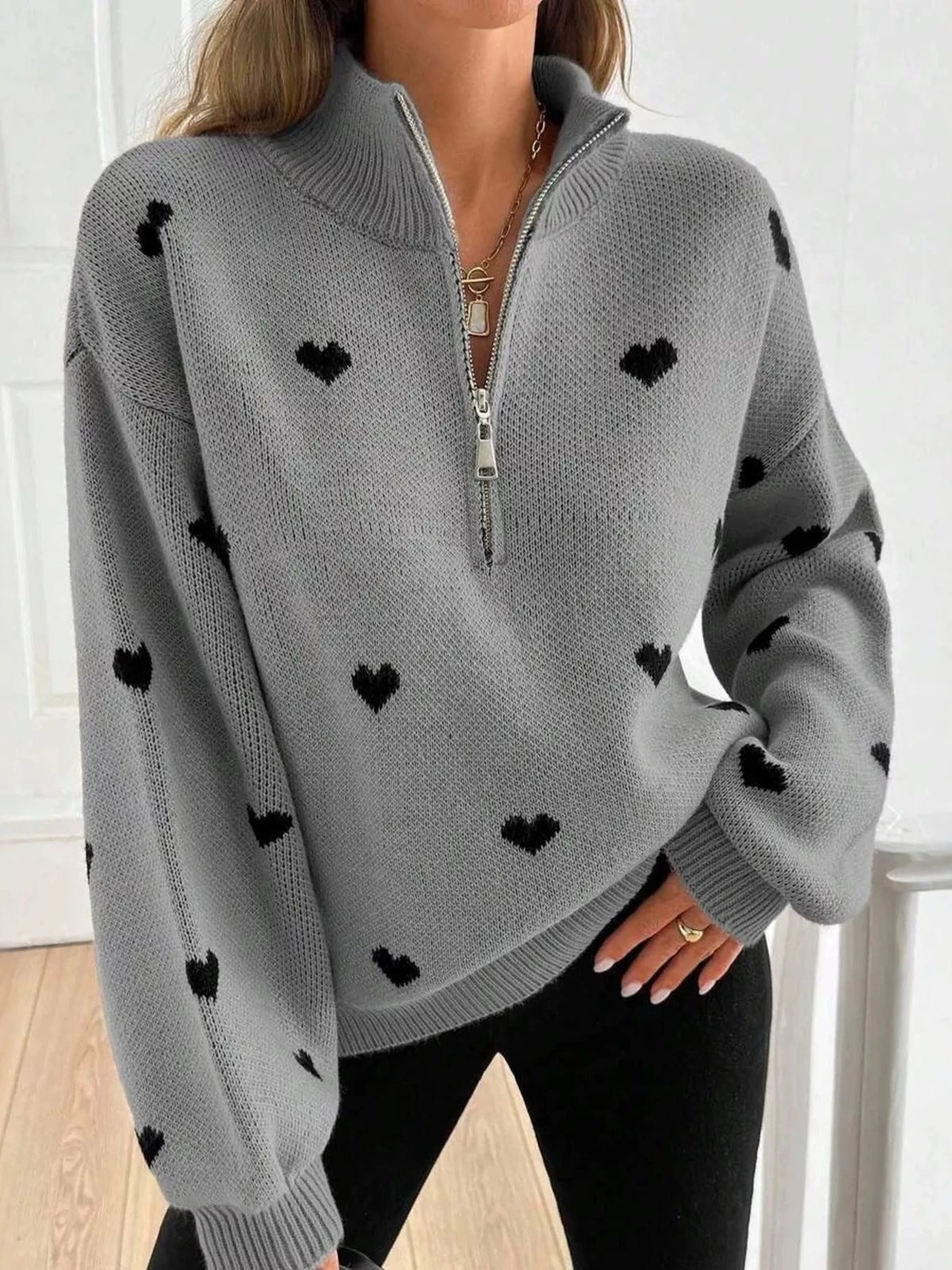 Plus size full heart half-zip long sleeve sweater by Trendsi, featuring a cozy design with a large heart detail on the front.