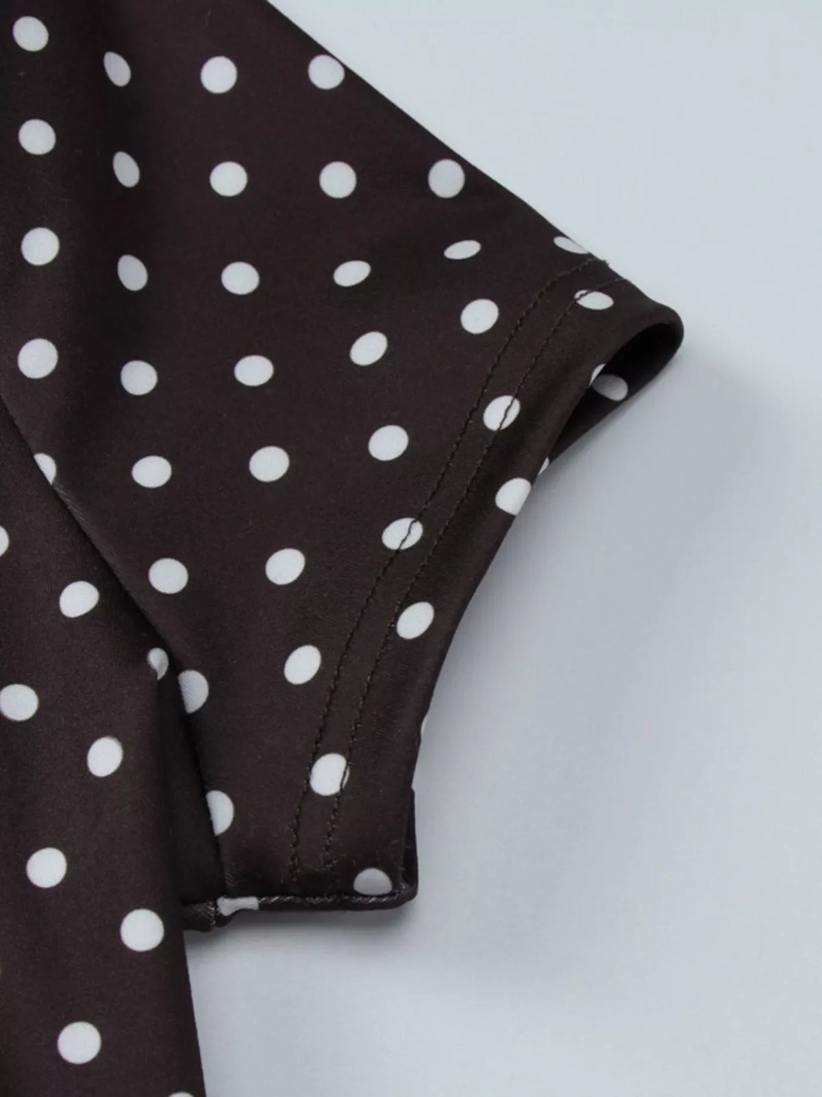Polka dot cut-out front mini dress by Plush Fashion Hub, featuring a stylish design with playful polka dots and a trendy cut-out detail.