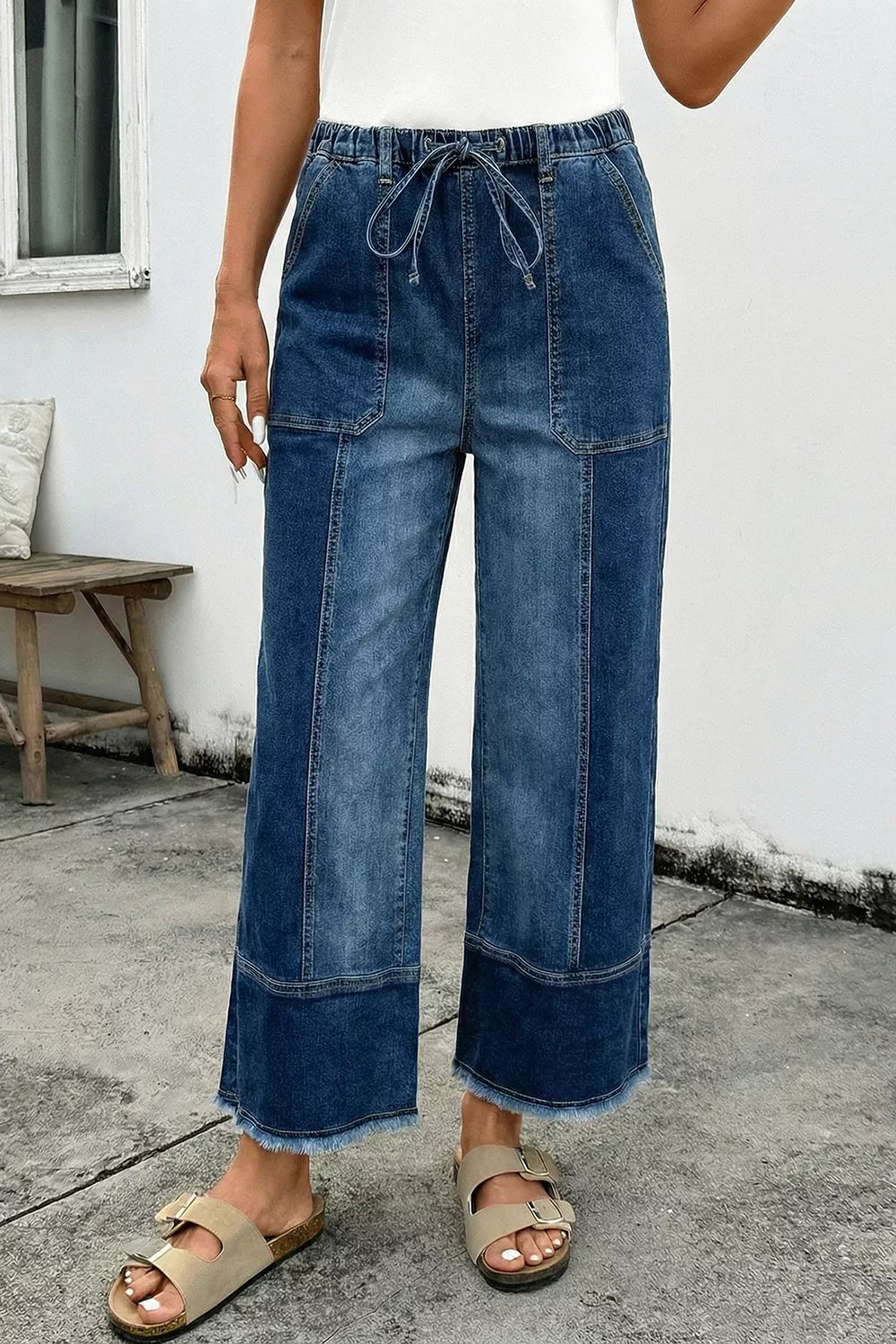 Wide-leg denim pants with drawstring waist, seam detail, and raw hem from Plush Fashion Hub, shown in a casual style.