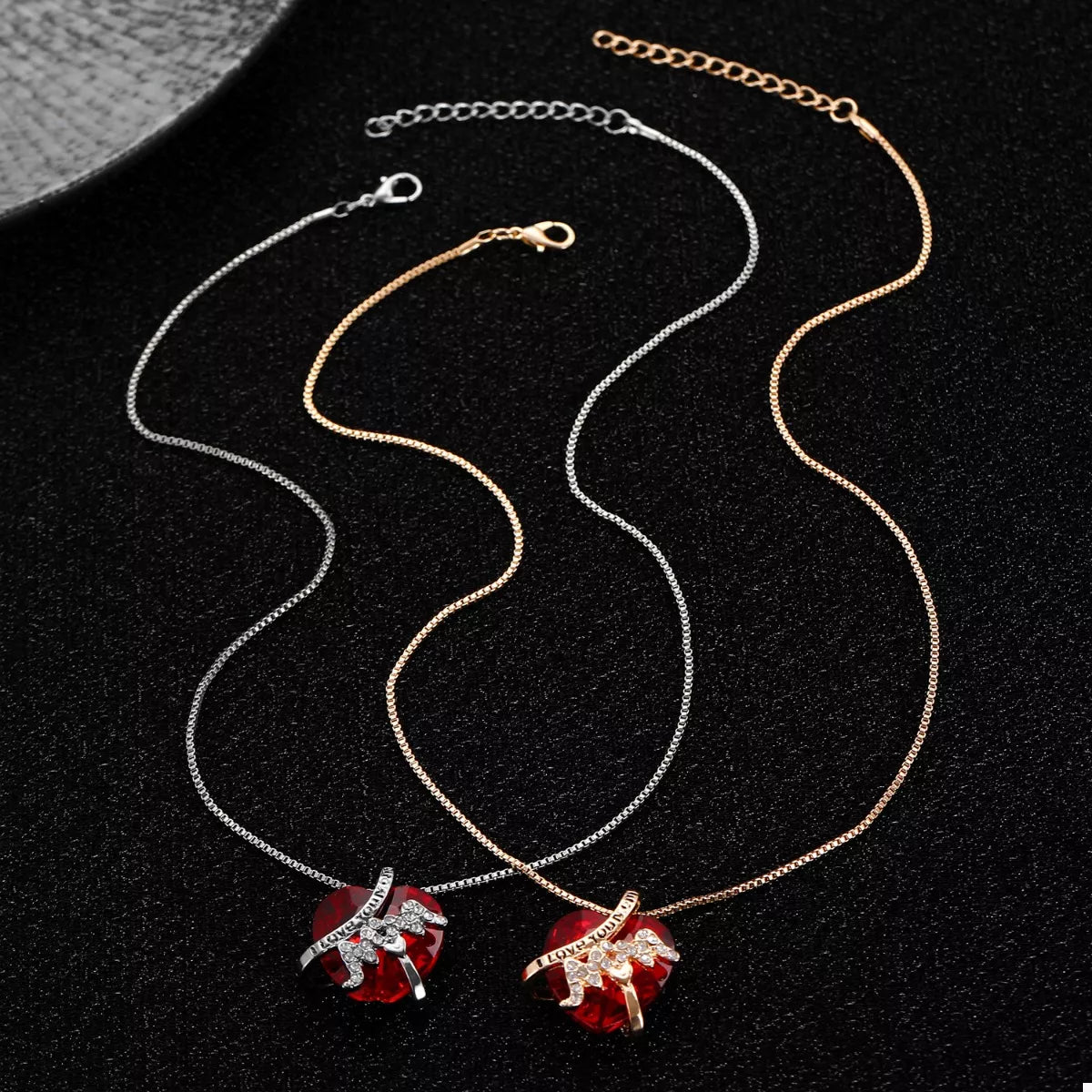 Heart-shaped MOM pendant necklace from Plush Fashion Hub featuring a silver-tone chain and a decorative heart charm.