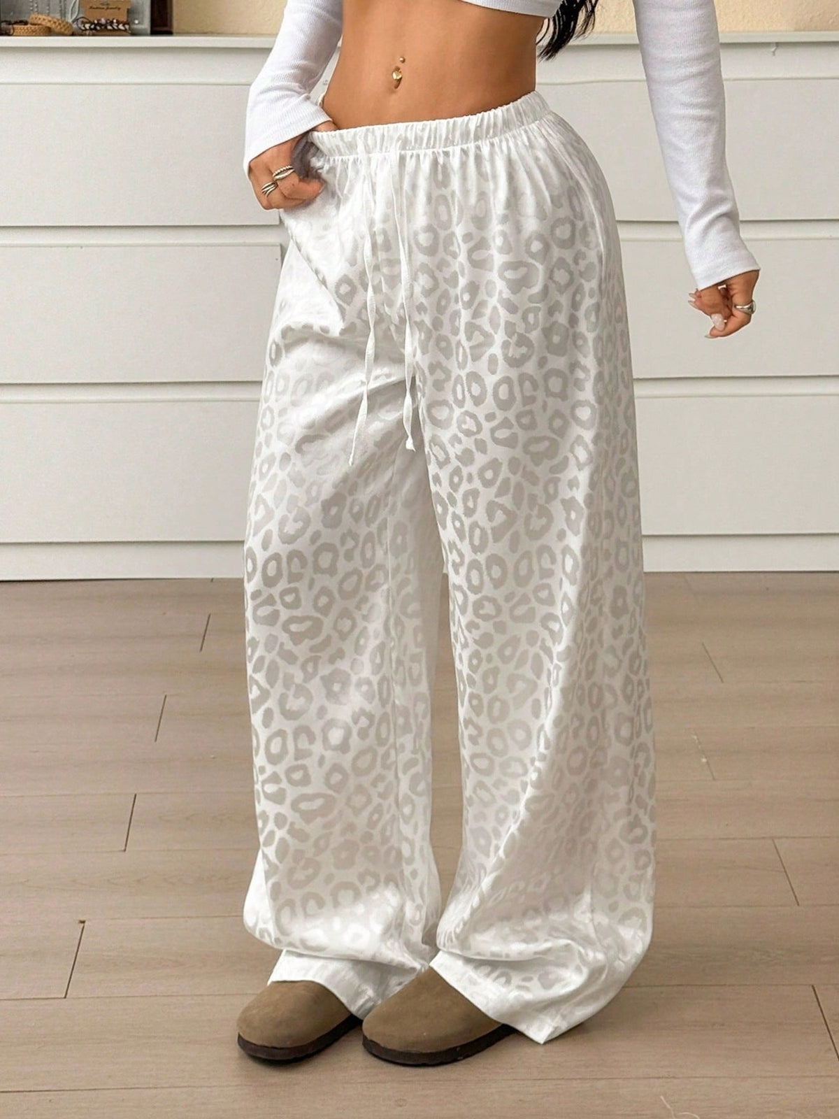 Women’s leopard print wide-leg trousers from Plush Fashion Hub with adjustable drawstring waist, featuring bold animal print fabric.