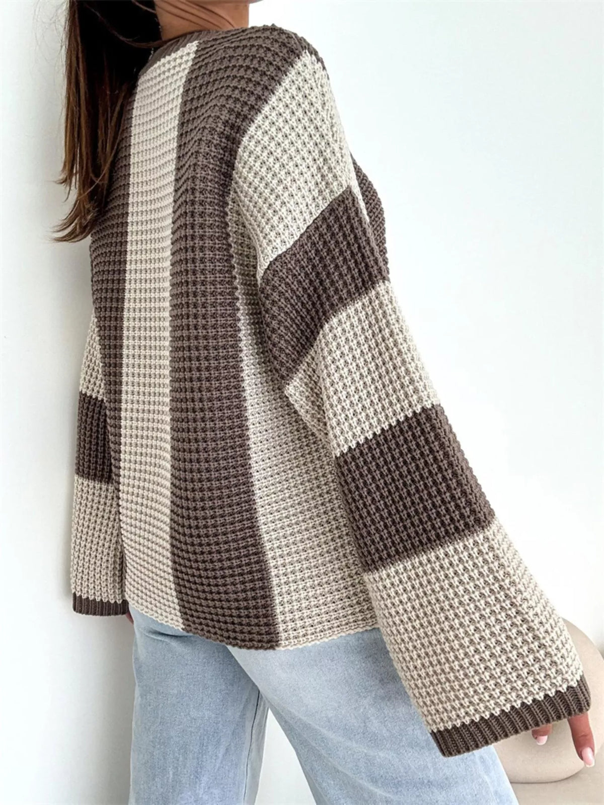 Color block long sleeve sweater by Trendsi featuring bold color sections and a cozy fit, shown on a model.