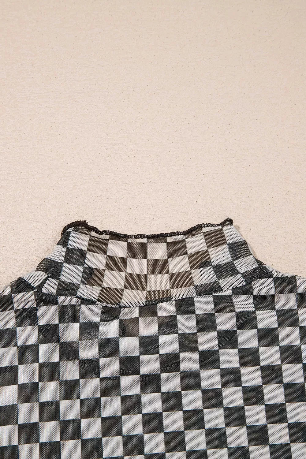 Plaid stand-neck long sleeve mesh top by Plush Fashion Hub, featuring a stylish checkered pattern and sheer fabric.
