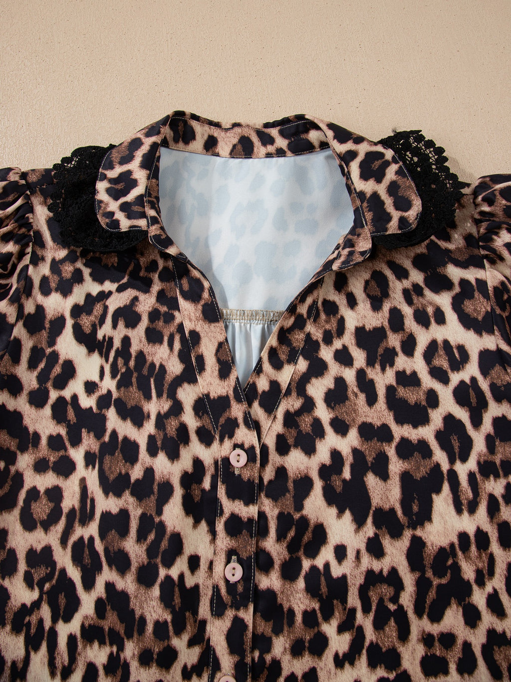 Leopard print short sleeve blouse with lace trim and button front, trendy women's top by Trendsi featuring bold animal print design.