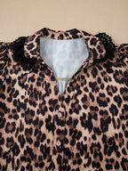 Leopard print short sleeve blouse with lace trim and button front, trendy women's top by Trendsi featuring bold animal print design.