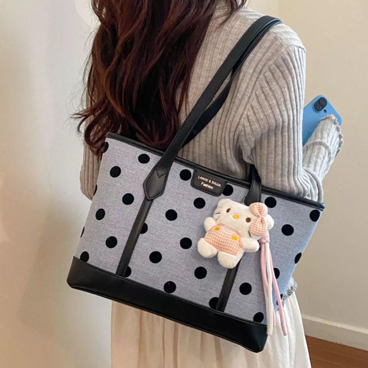 Polka dot women's shoulder handbag by Trendsi featuring a stylish, lightweight design with a top handle and adjustable strap.