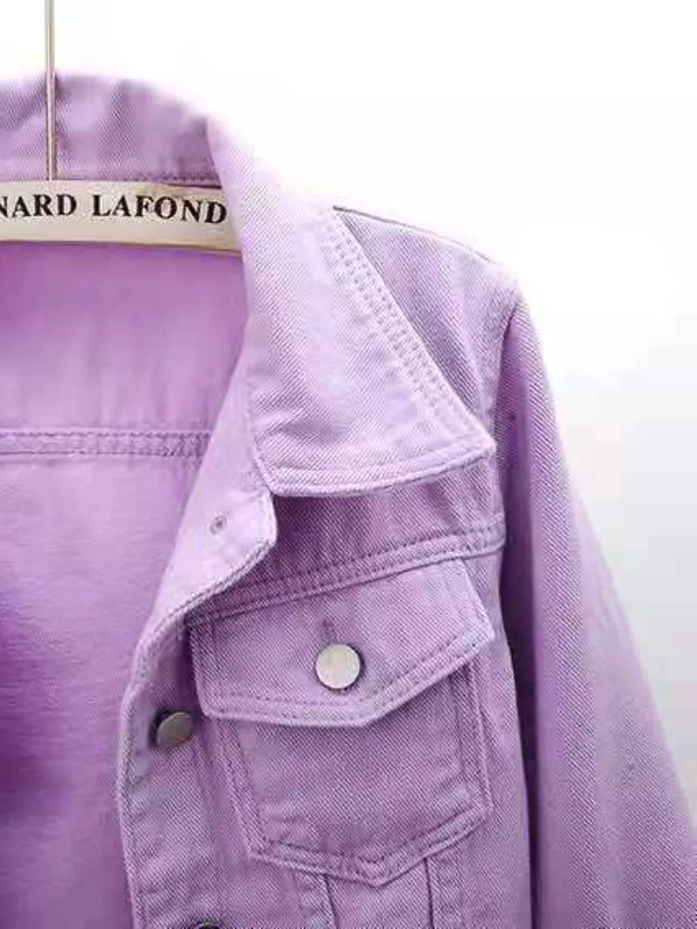 Plus size full length cropped denim jacket from Trendsi, featuring classic blue denim with long sleeves and button closure.