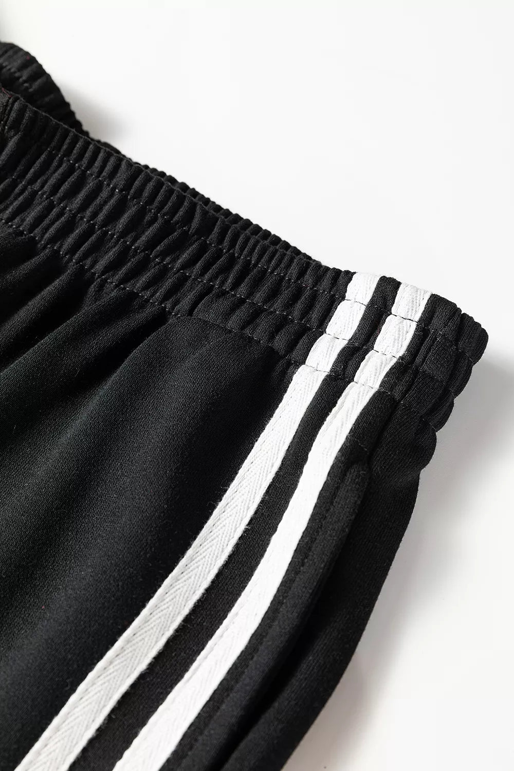 Striped detail crewneck pullover and elastic sweatpants set by Trendsi, casual loungewear with comfortable fit and stylish stripes.