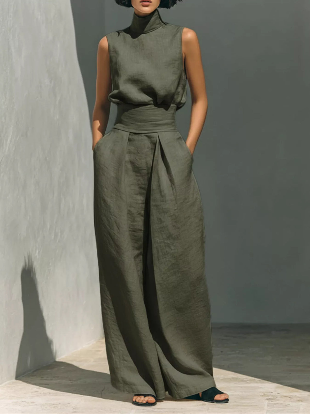 Plus size full length sleeveless wide-leg jumpsuit with smocked waist by Trendsi, shown in a natural pose highlighting the fit.