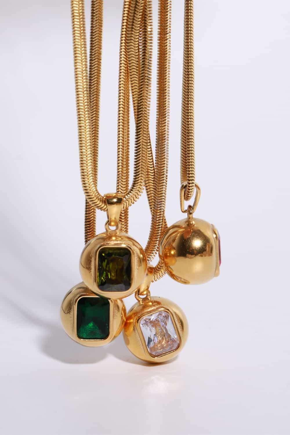 Gold-plated geometrical zircon pendant necklace with sleek design, featuring cubic zirconia stones on a delicate chain.