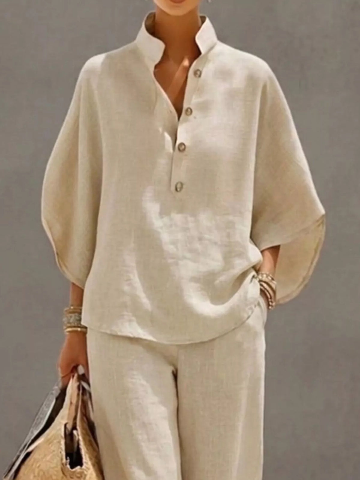 Plus size women's two-piece set with button-detail 3/4 sleeve top and matching pants from Plush Fashion Hub