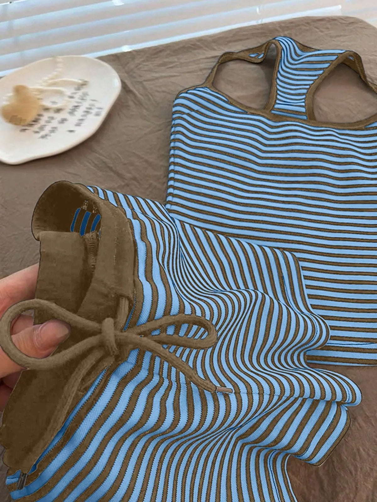 Striped tank top and shorts set by Plush Fashion Hub, featuring a casual summer outfit with vibrant stripes and comfortable fabric.