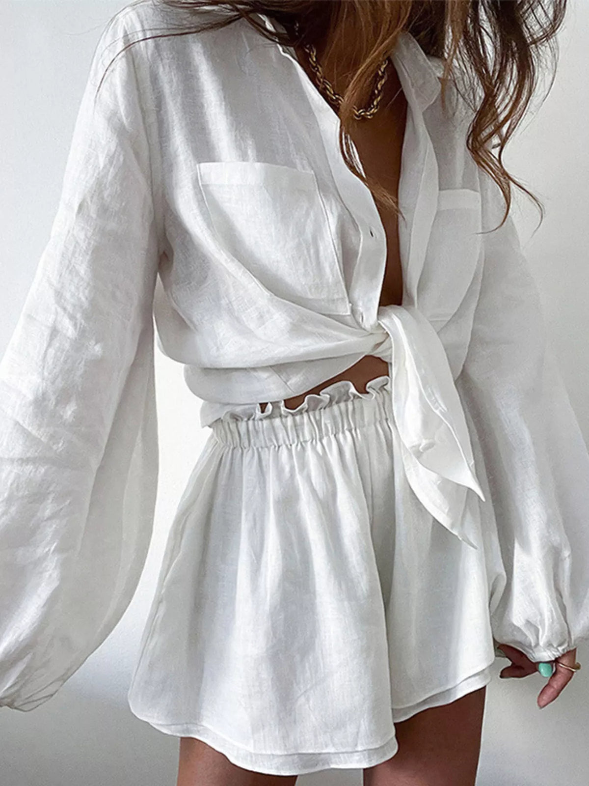 Plush Fashion Hub two-piece long sleeve shirt and shorts set, featuring a plush fabric design and stylish button-up top.