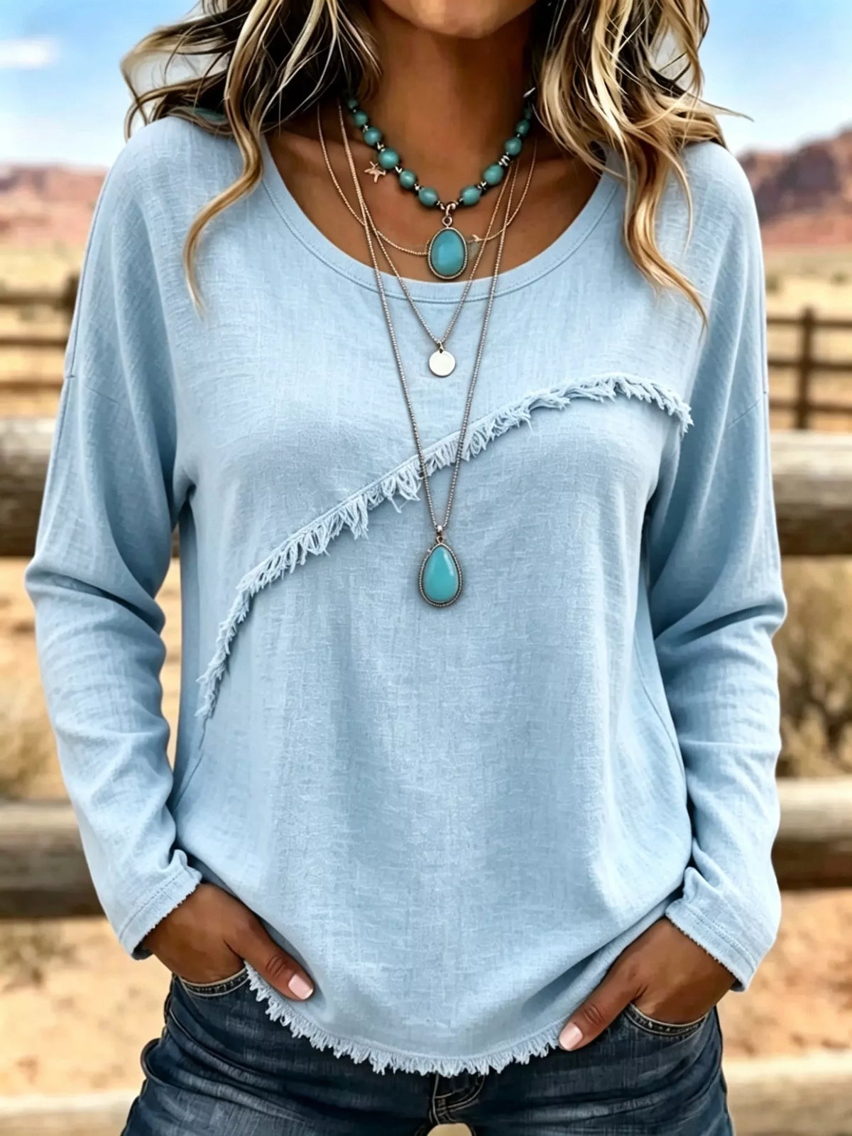 Plus size long sleeve fringe detail T-shirt from Trendsi, featuring a casual fit with decorative fringe accents on the sleeves.