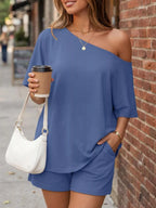 Plus size full size one-shoulder top and shorts set by Trendsi, featuring a stylish coordinated ensemble in a vibrant fabric.