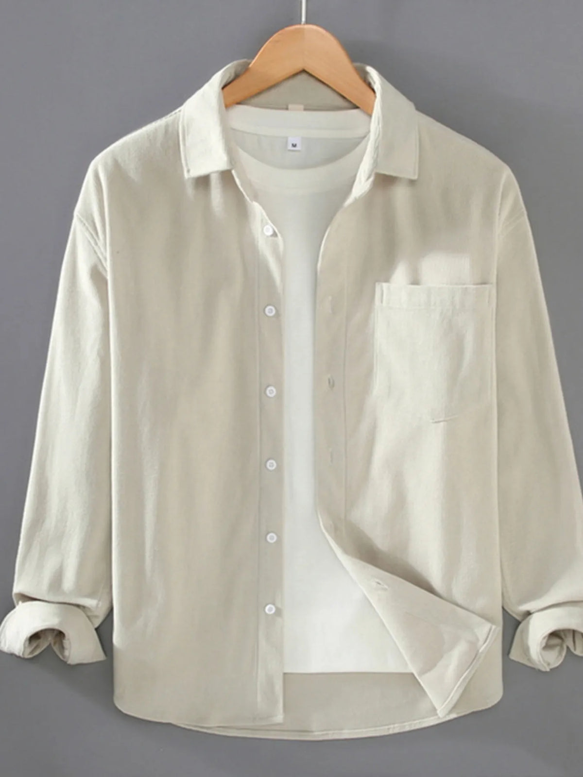 Plus size men's button-up long sleeve shirt by Trendsi, featuring a classic fit and stylish design for casual or formal wear.