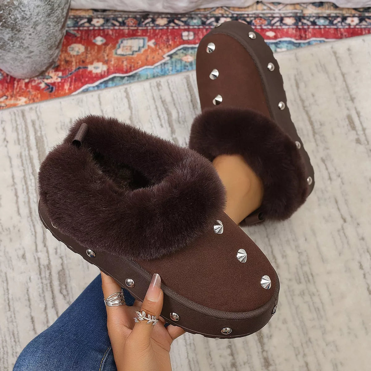 Studded platform winter boots with faux fur lining and chunky soles, designed for cold weather and trendy winter style.