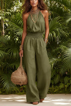 Women's black halter-neck backless wide-leg jumpsuit by Plush Fashion Hub, stylish streetwear with a solid color design.