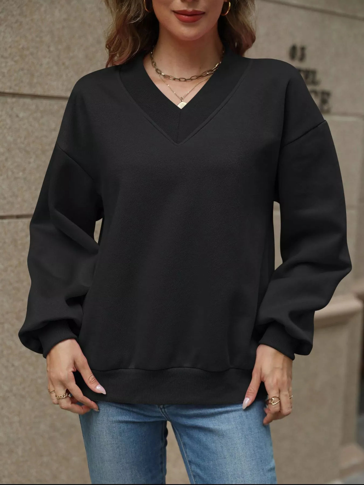 Gray V-neck solid color casual sweatshirt from Trendsi, featuring a relaxed fit and soft fabric, displayed on a hanger.