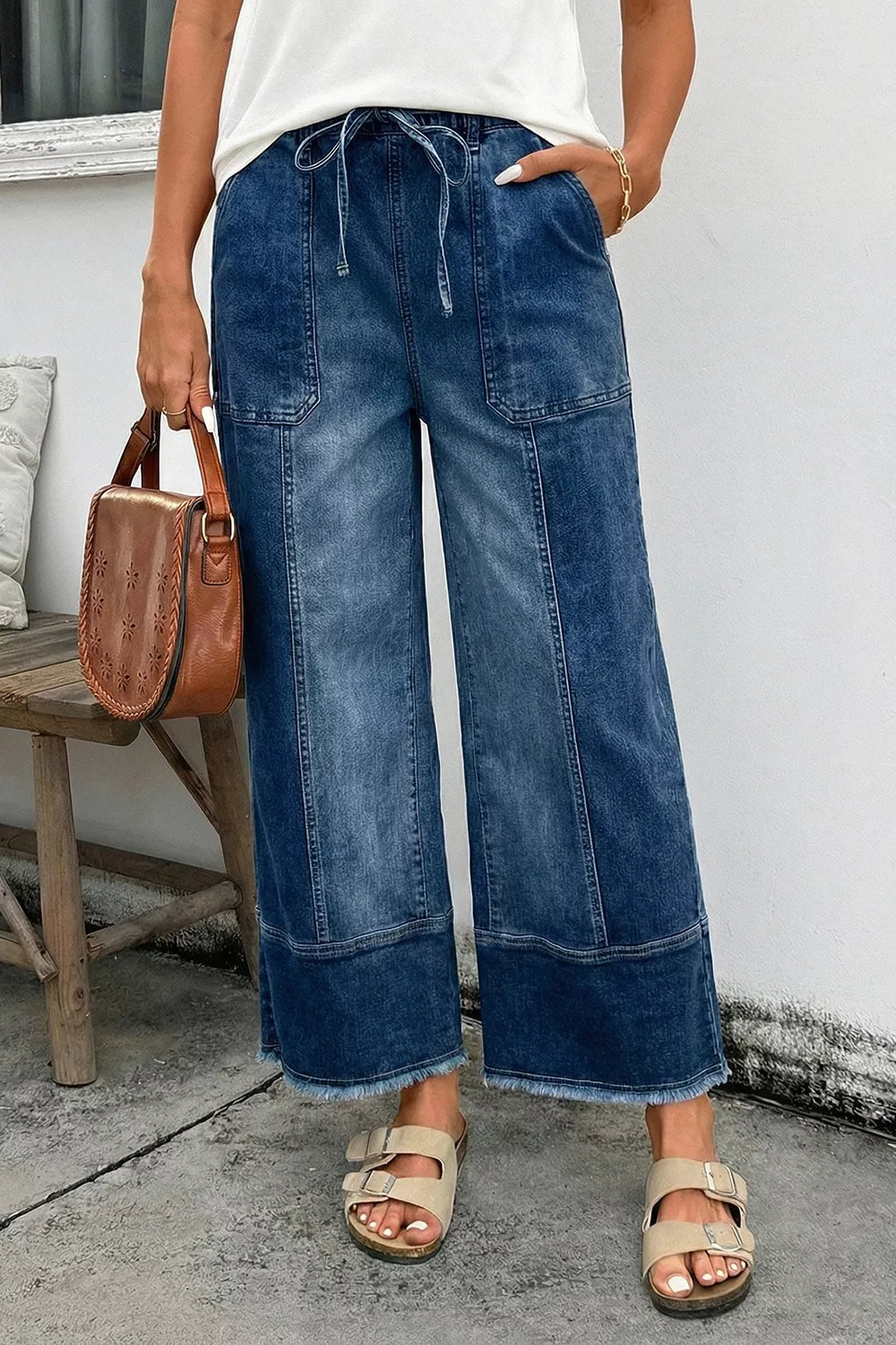 Wide-leg denim pants with drawstring, seam details, and raw hem from Plush Fashion Hub, shown in a full-length image.