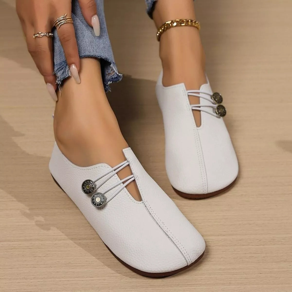 Women's casual slip-on shoes with button detail by Trendsi, featuring a comfortable and stylish design, shown in a neutral color.