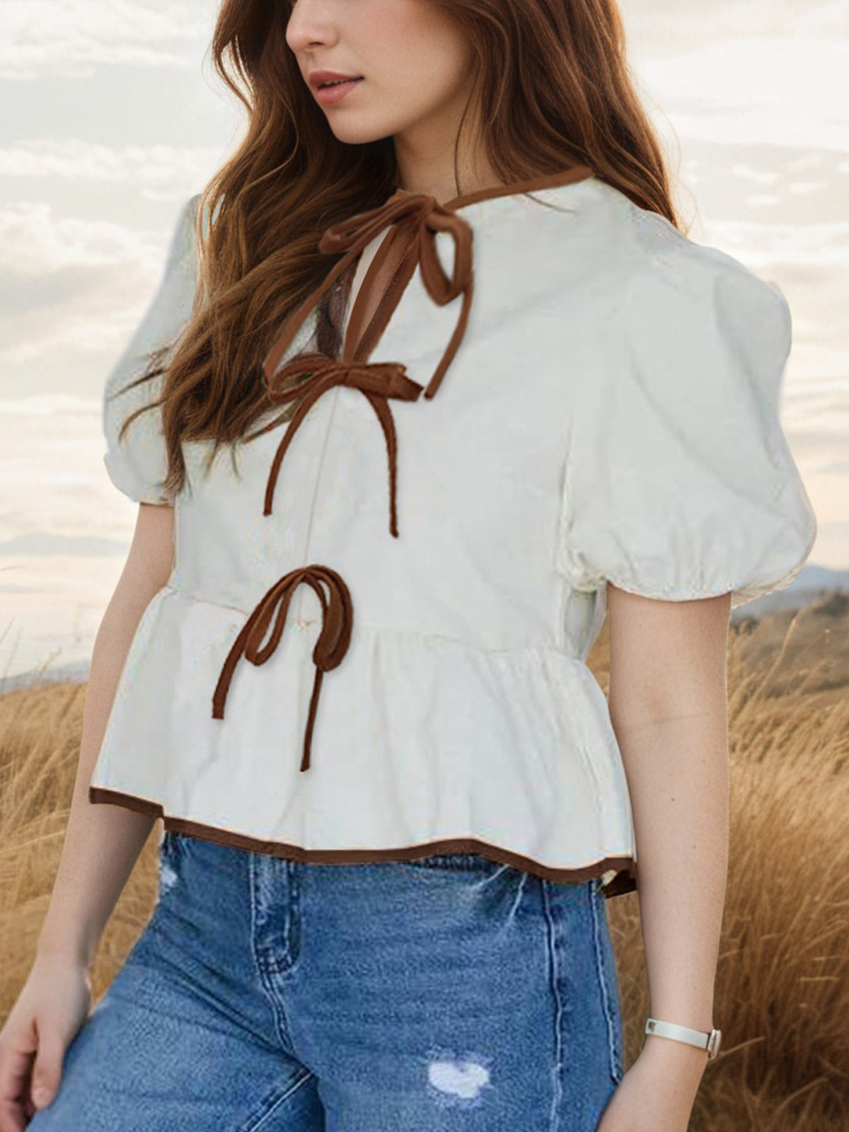 Elegant tie-front puff sleeve peplum blouse by Plush Fashion Hub, featuring a stylish design and feminine details, shown on a model.