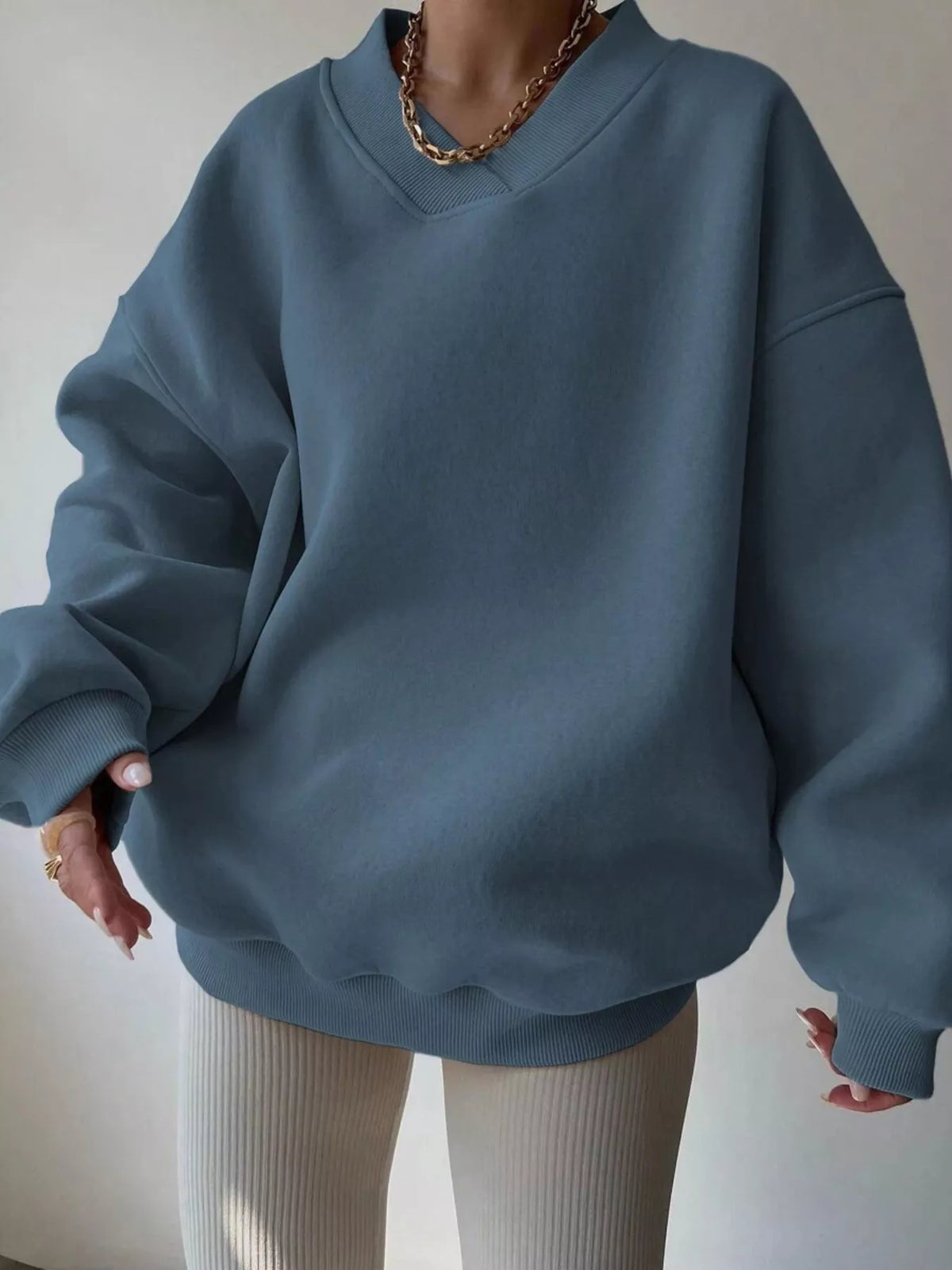 Gray dropped shoulder oversized sweatshirt from Trendsi featuring long sleeves and a relaxed fit, perfect for casual wear.