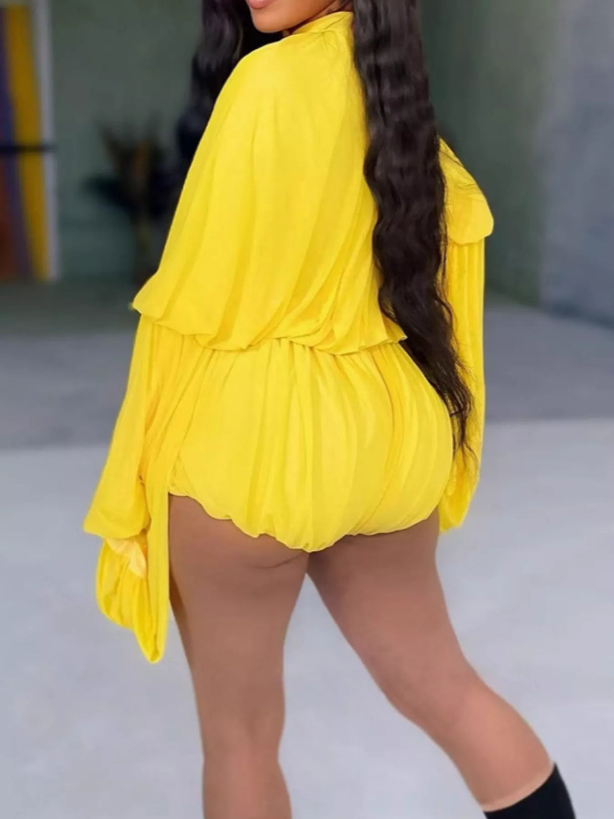 Elegant pleated bell sleeve romper by Trendsi, featuring flowy fabric, stylish bell sleeves, and a chic, modern design.