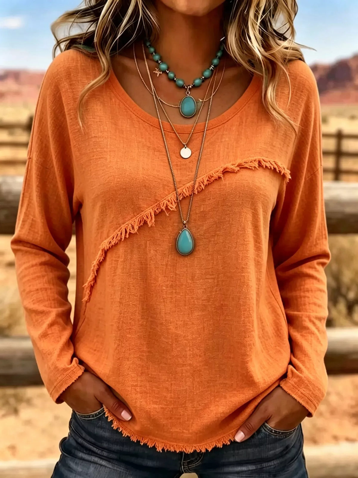 Plus size long sleeve fringe detail T-shirt from Trendsi, featuring a comfortable fit and stylish fringe accents on the sleeves.