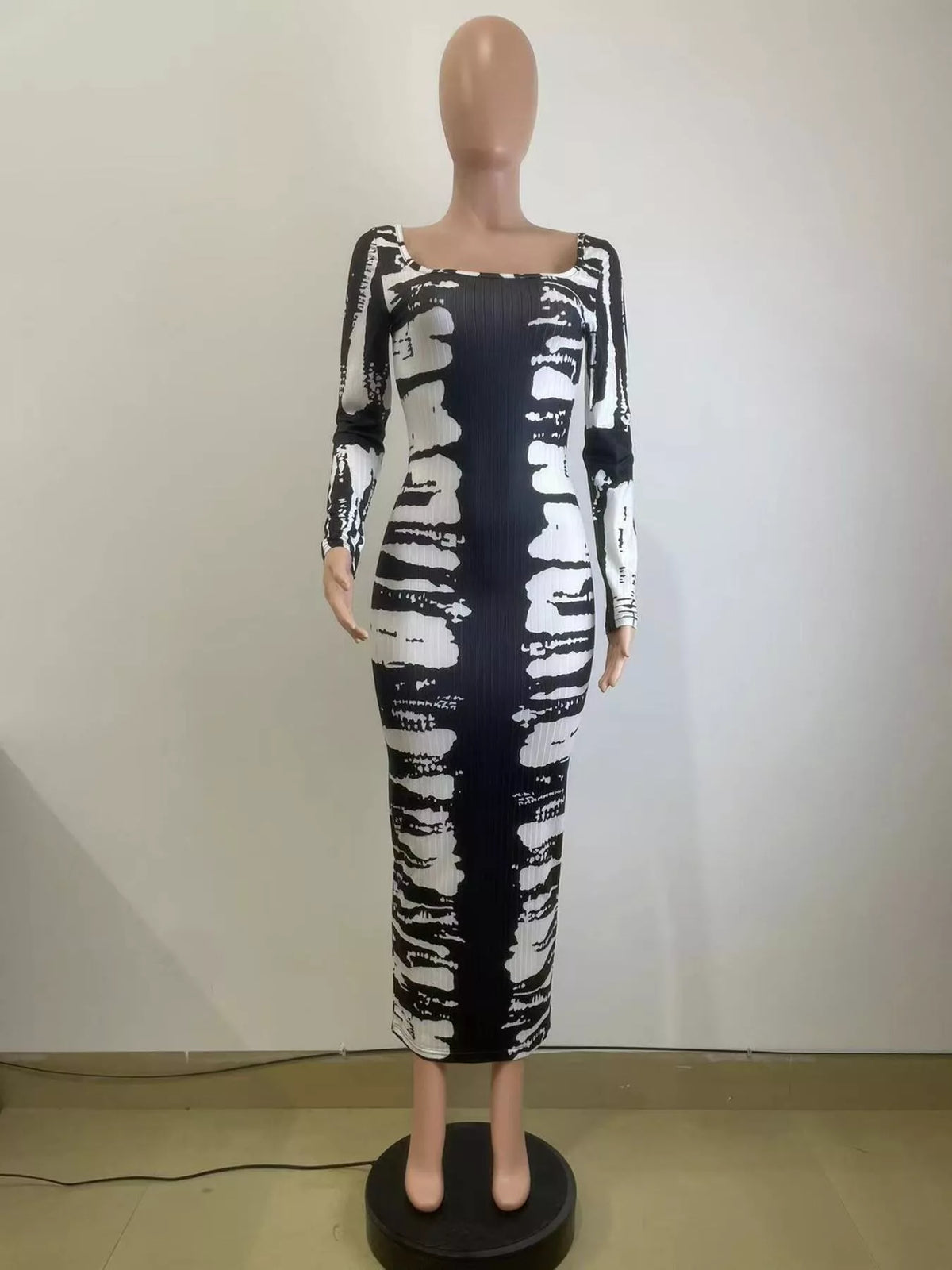 Colorful tie-dye long sleeve maxi dress by Plush Fashion Hub featuring a flowing silhouette and vibrant pattern.