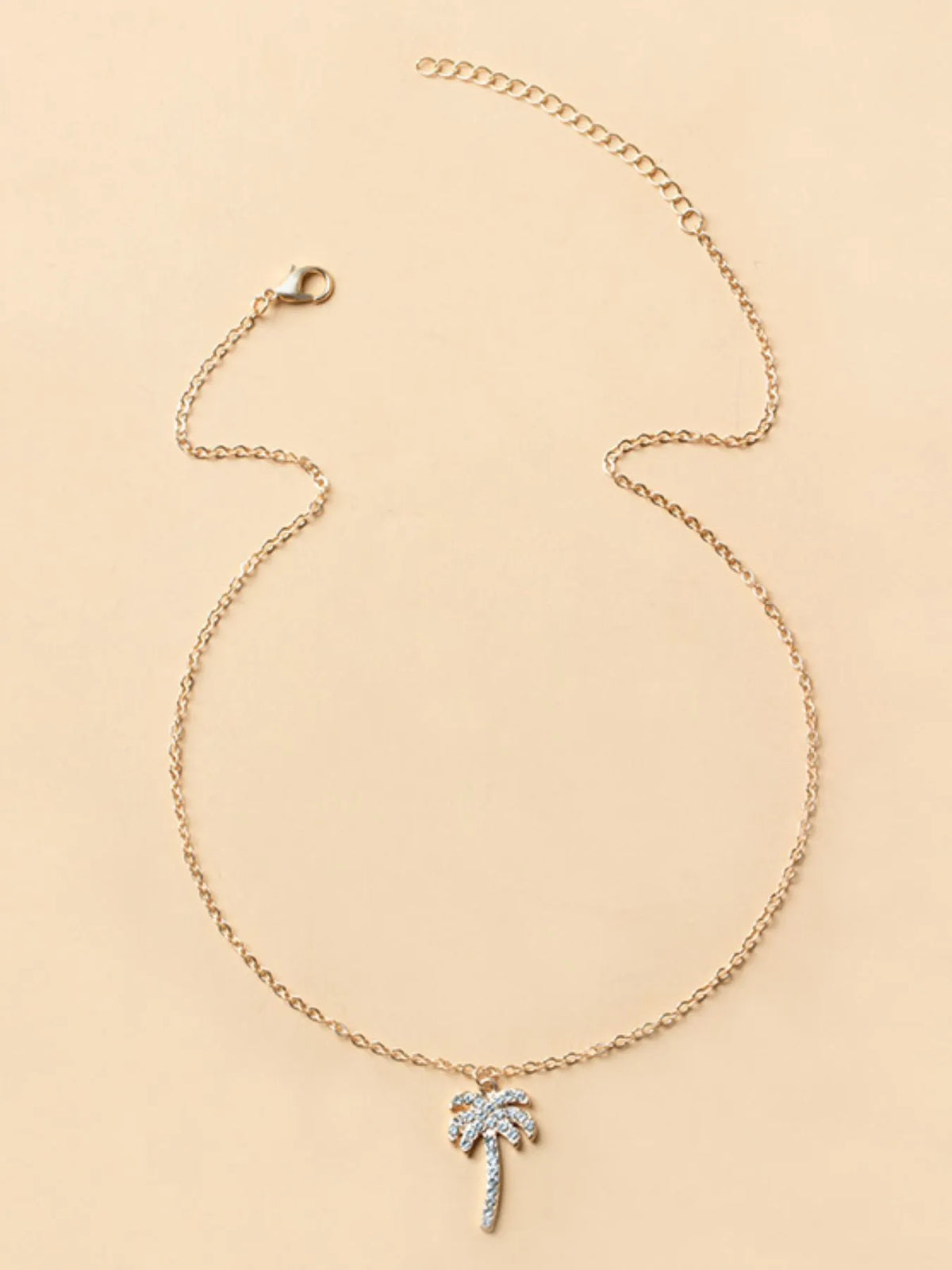 Silver zircon palm tree pendant necklace from Plush Fashion Hub, featuring a detailed palm tree charm on a delicate chain.