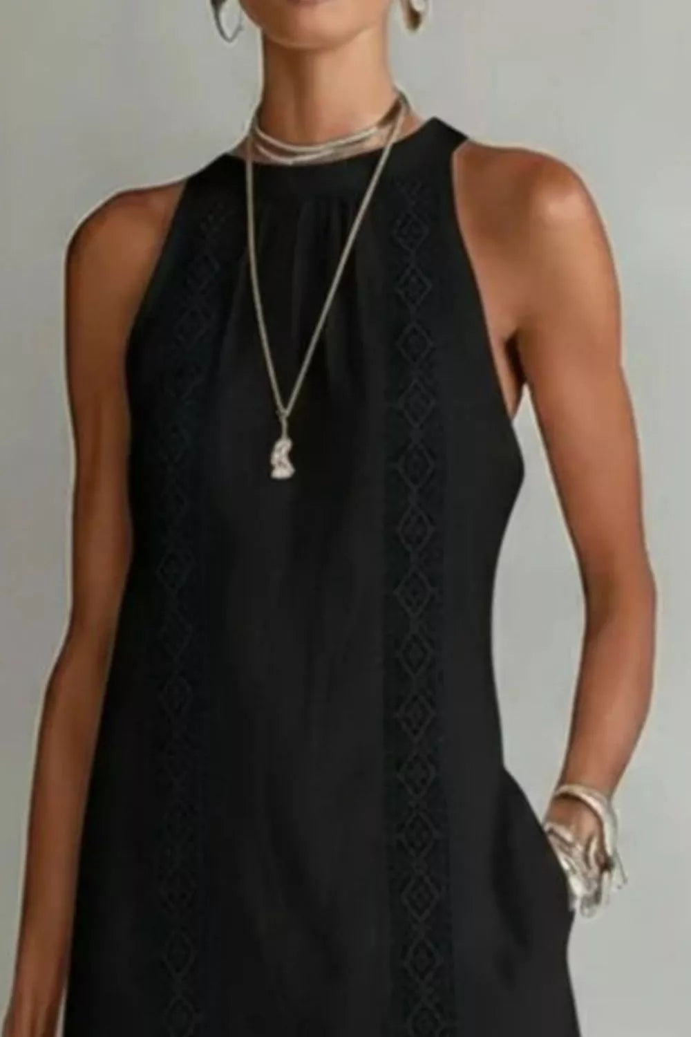 Women's sleeveless maxi dress with side slit and pockets by Trendsi, featuring a flowing silhouette and stylish design.
