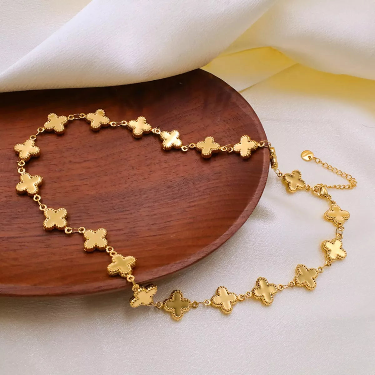 18K gold-plated clover charm necklace featuring a delicate pendant on a fine chain, styled for a elegant look.