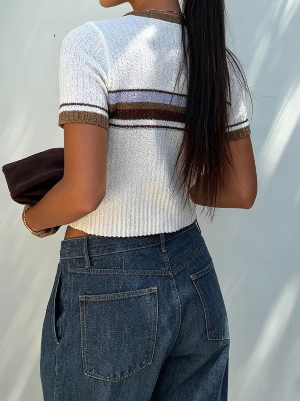 Women's striped short sleeve knit top by Trendsi, featuring a fitted design with colorful horizontal stripes and a round neckline.