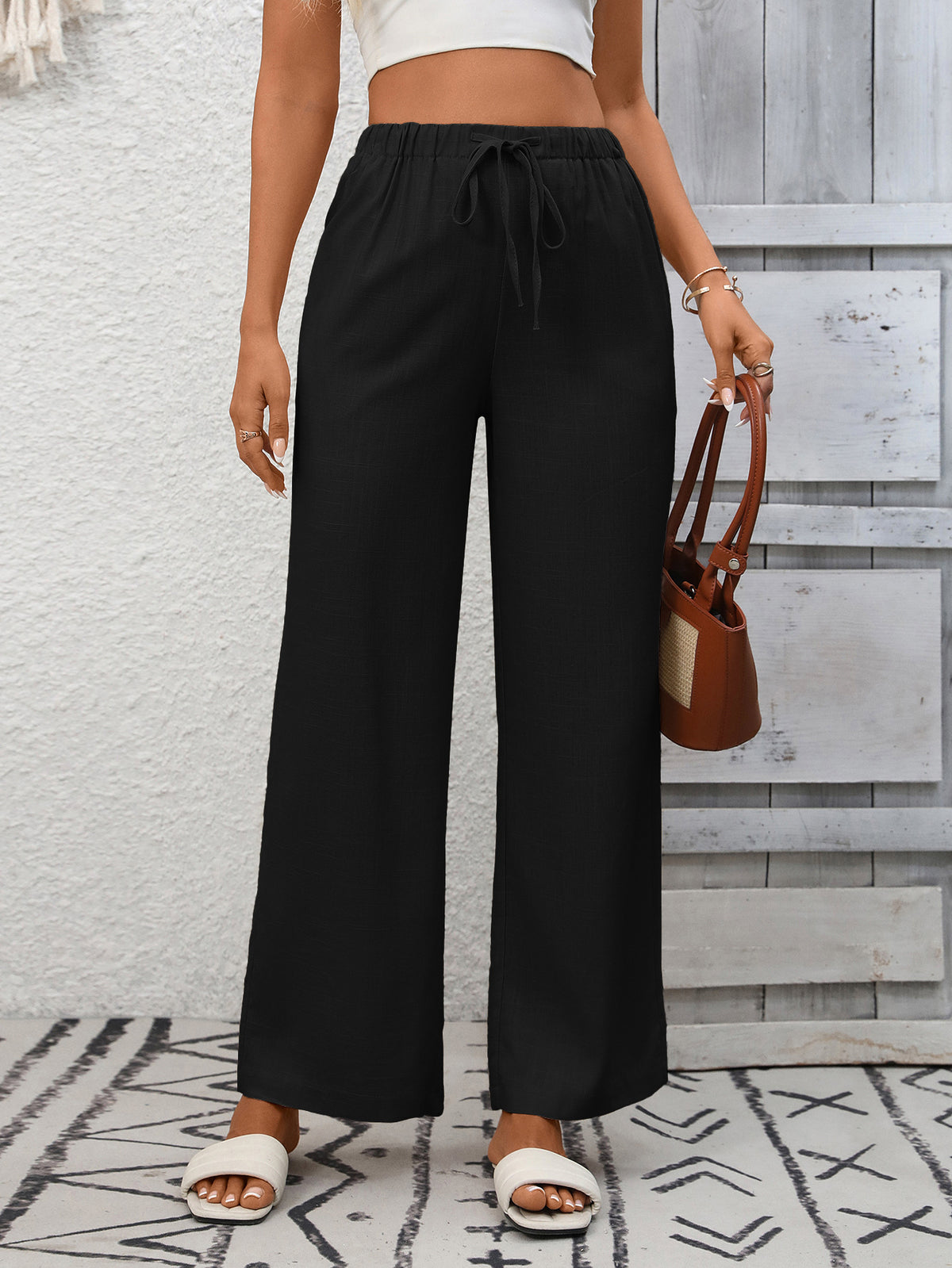 Women's high-waisted wide-leg drawstring pants in soft, breathable viscose with relaxed fit and comfortable waistband.