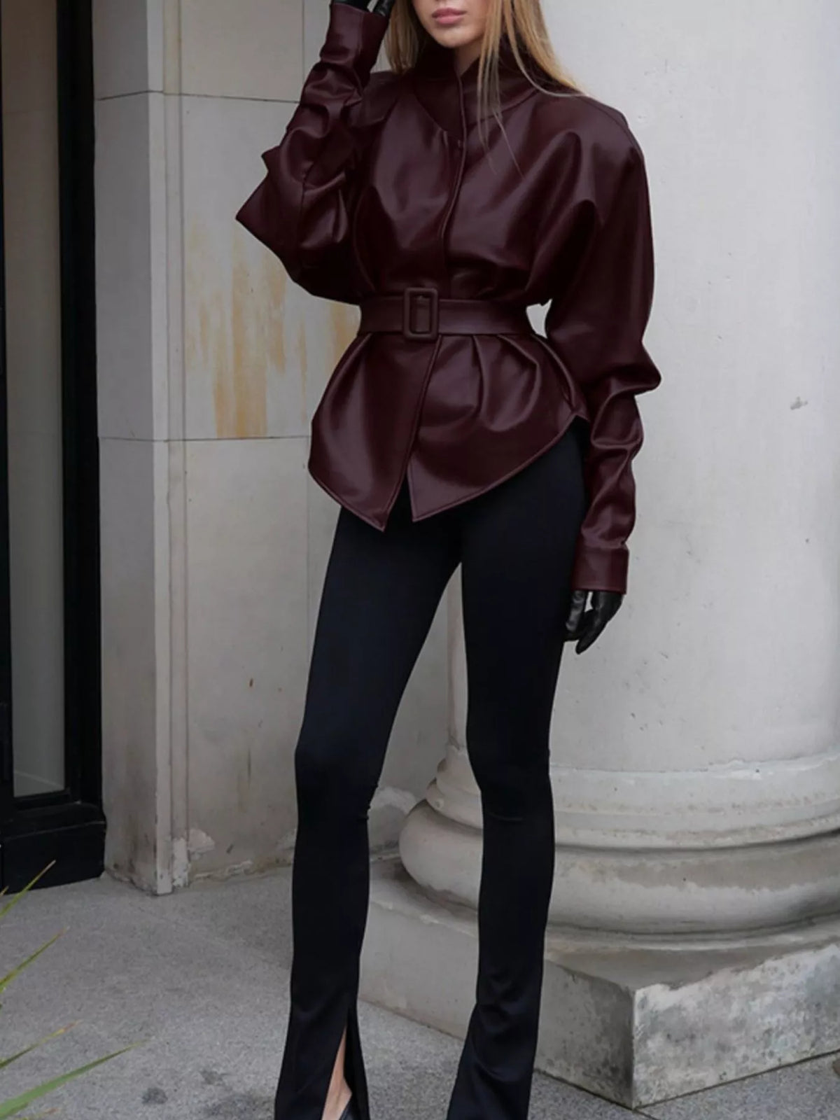 Women's faux leather jacket with stand collar and belt, trendy outerwear by Trendsi featuring a sleek, stylish design.
