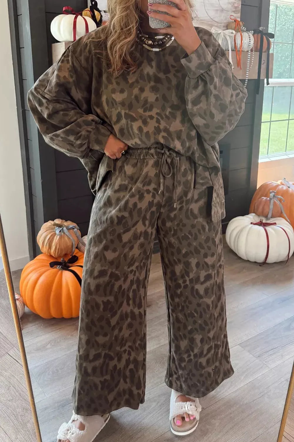 Leopard print long sleeve top and matching pants set by Trendsi, featuring a stylish animal print design.