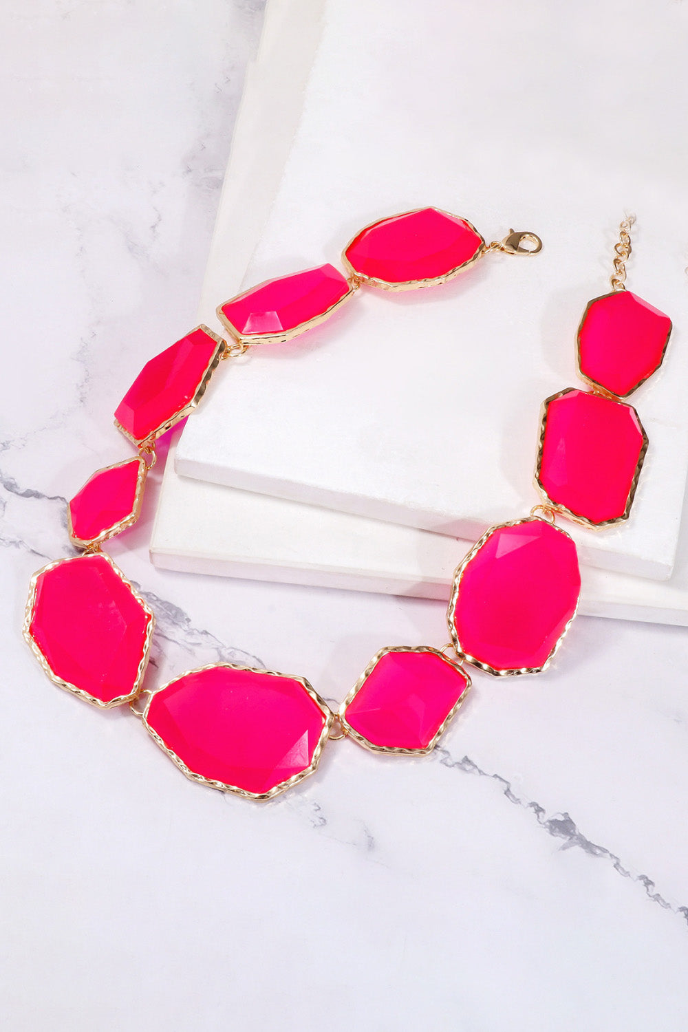 Geometrical resin necklace with zinc alloy frame, stylish jewelry piece from Plush Fashion Hub featuring modern design.