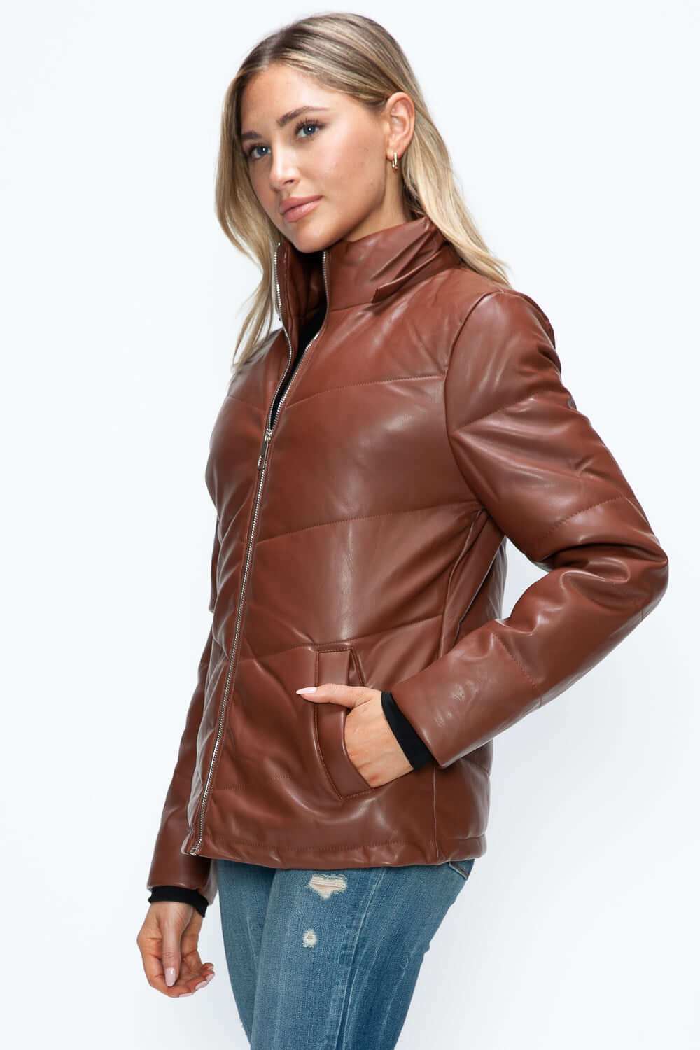 Pocketed zip up puffer jacket with removable hood in brown pleather.