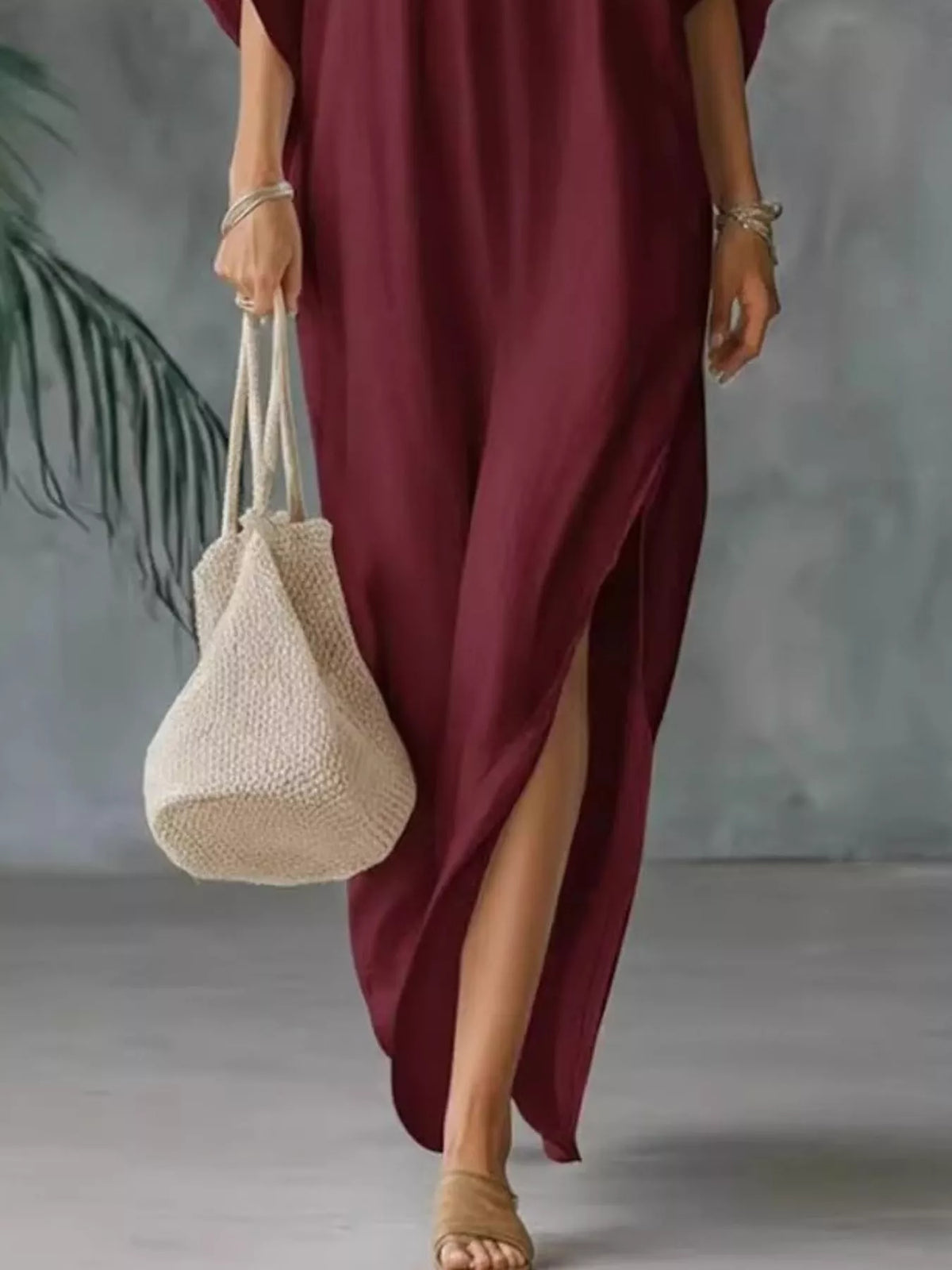 Plush Fashion Hub plus size V-neck maxi dress with side slits, flowing fabric and full-length design on a model.
