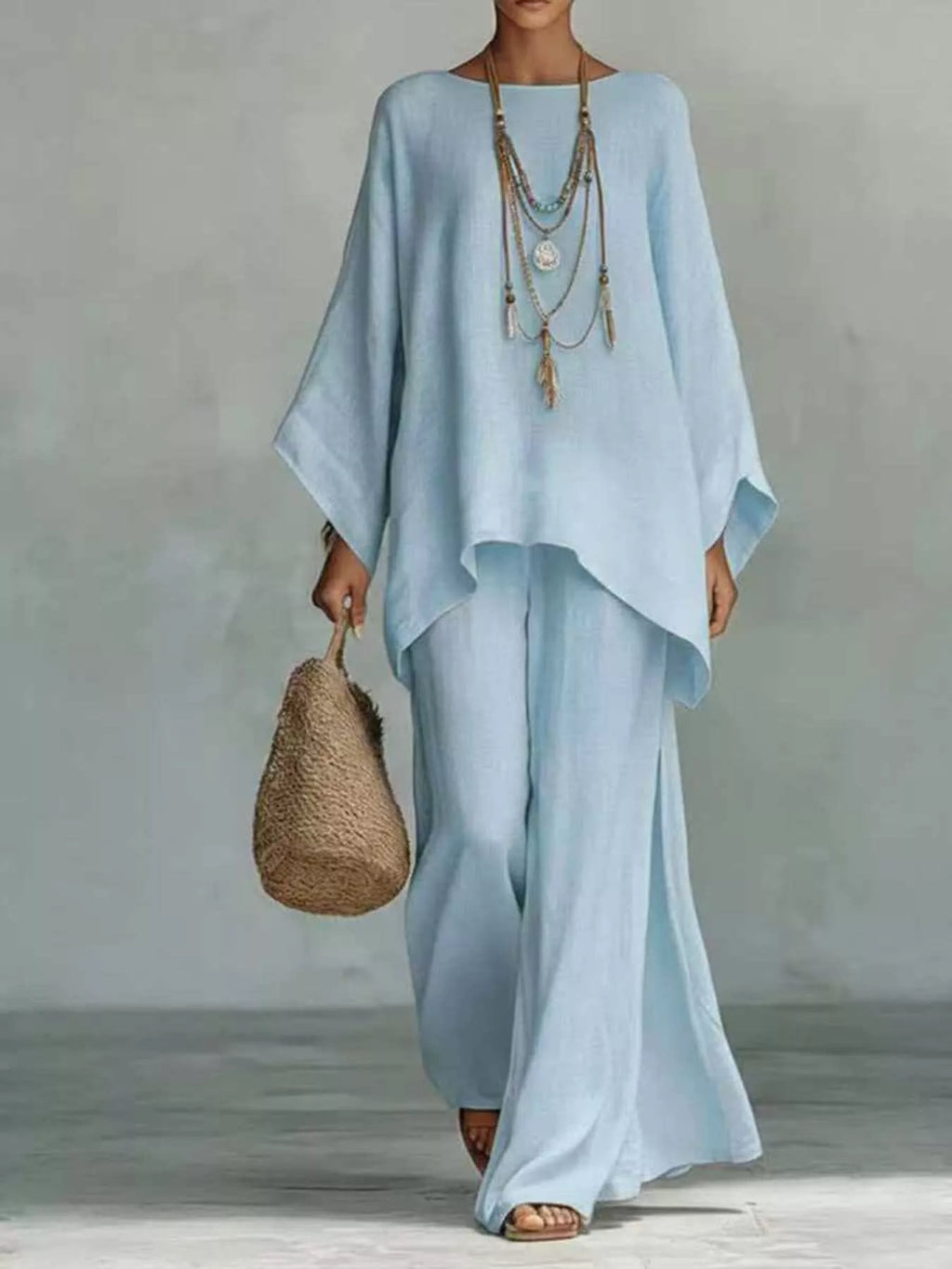 Plus size full size round neck top and wide-leg pant set by Trendsi, featuring a comfortable, stylish matching outfit.
