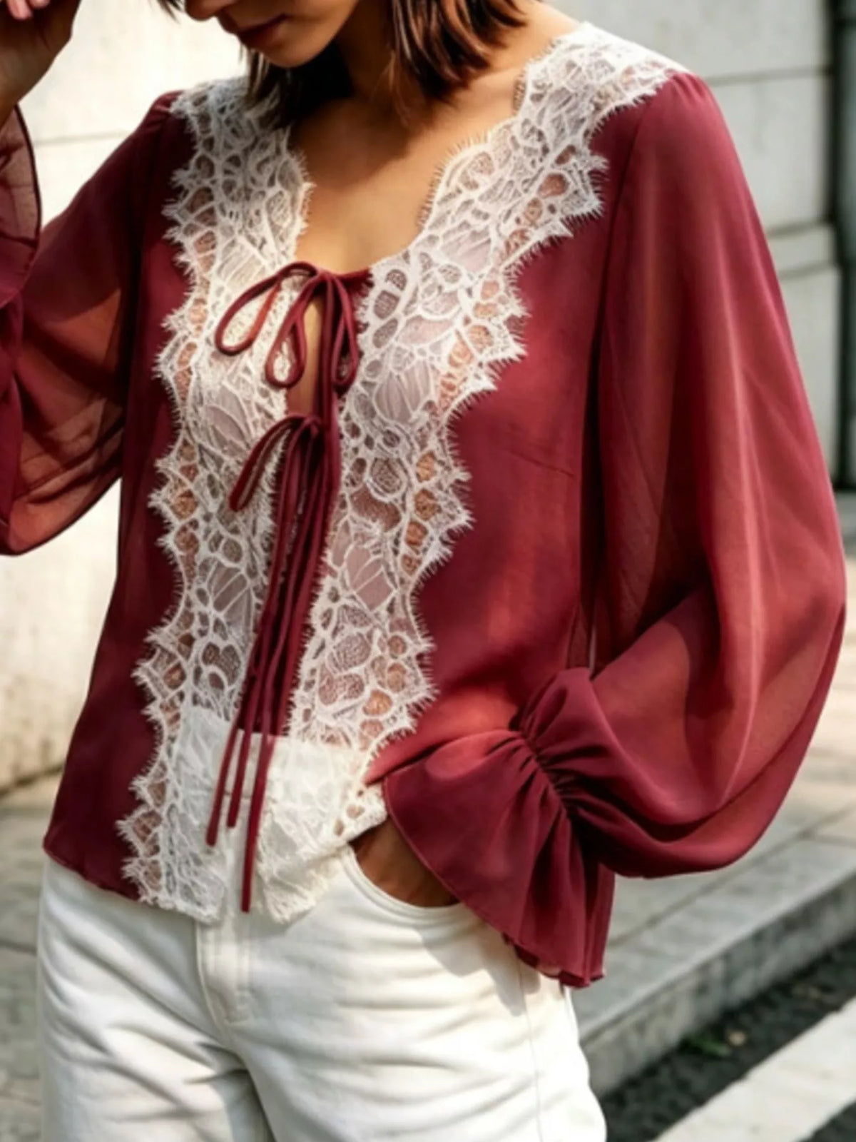 Sheer lace-trimmed front tie blouse for women, featuring lightweight fabric and stylish design from Trendsi.