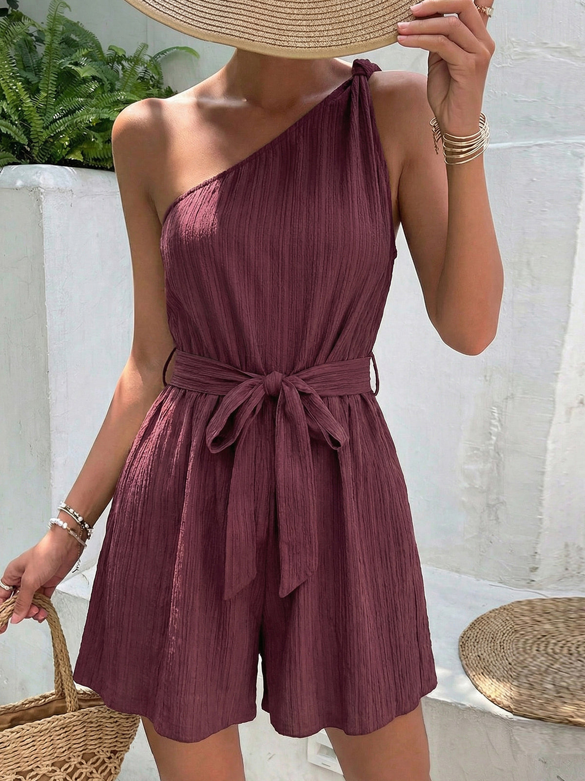 Plush Fashion Hub one-shoulder tie-waist polyester romper jumpsuit with stylish design and fitted silhouette.
