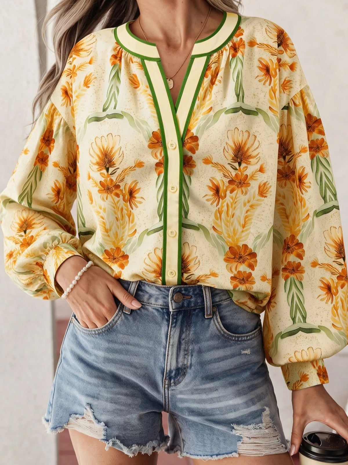 Floral print V-neck long sleeve blouse by Plush Fashion Hub, featuring a stylish design and vibrant floral pattern.