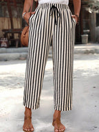 Women’s striped high-waisted cropped pants with pockets, stylish bottoms by Trendsi, shown in a casual pose.