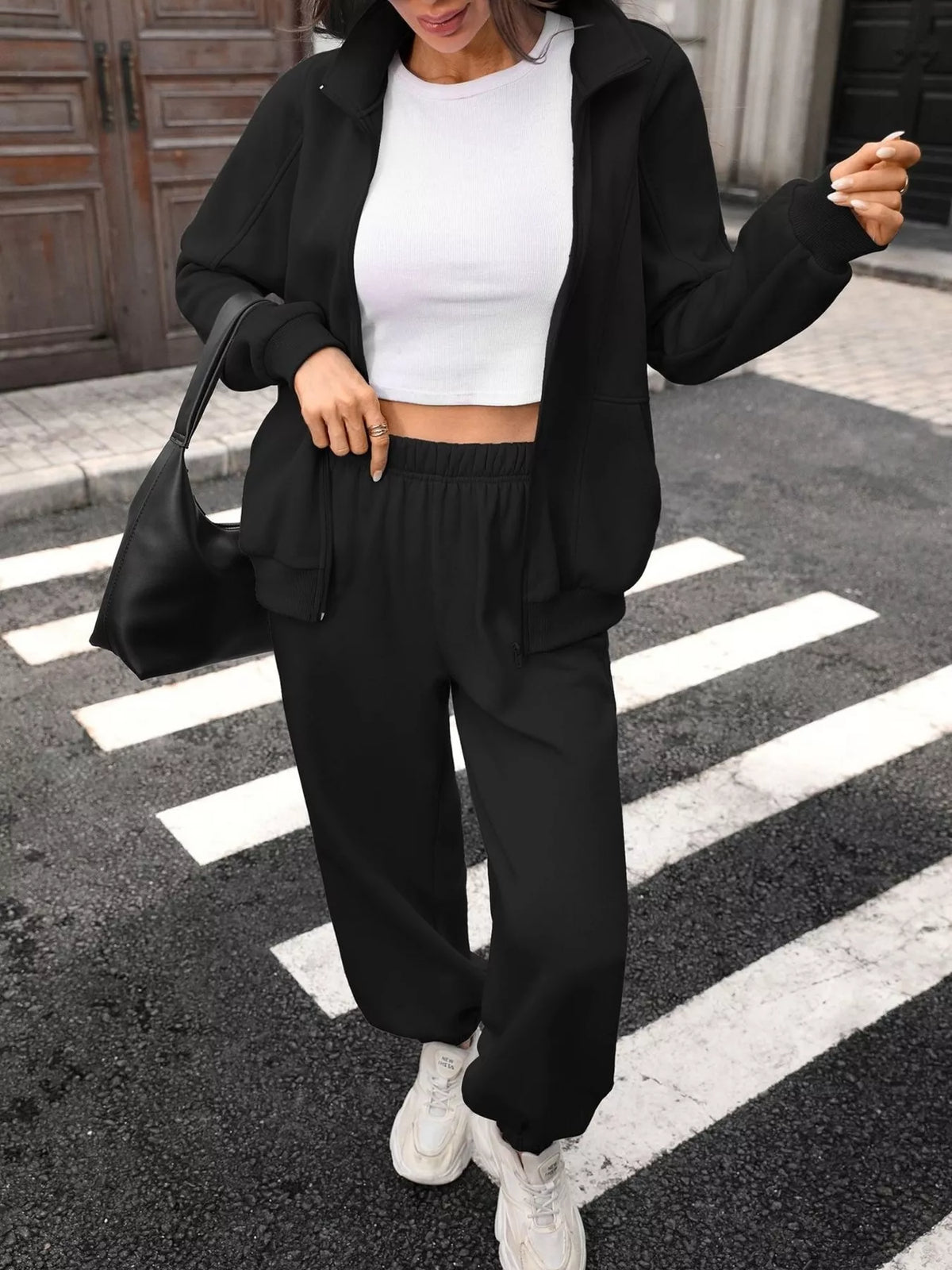 Women’s zip-up long sleeve top and pants set by Trendsi, featuring a coordinated matching outfit with comfortable fabric.
