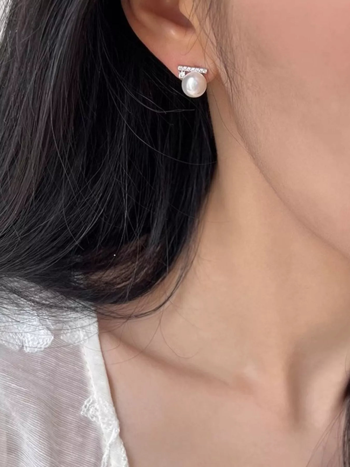 Plush Fashion Hub zircon and pearl stud earrings featuring round white pearls and sparkling zircon stones on a silver setting.