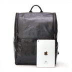 Black leather computer backpack from Pi-Mart with multiple compartments and padded shoulder straps, designed for everyday use.