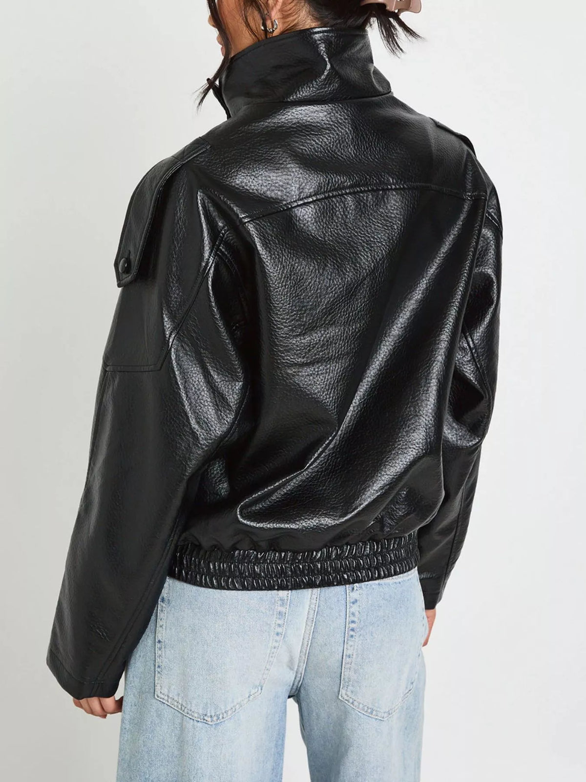 Women's faux leather moto jacket with asymmetrical zipper, trendy black jacket featuring stylish lapels and silver hardware.